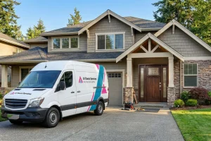 A1 Door Services van parked in the driveway of a two-story craftsman home with a wood front door.