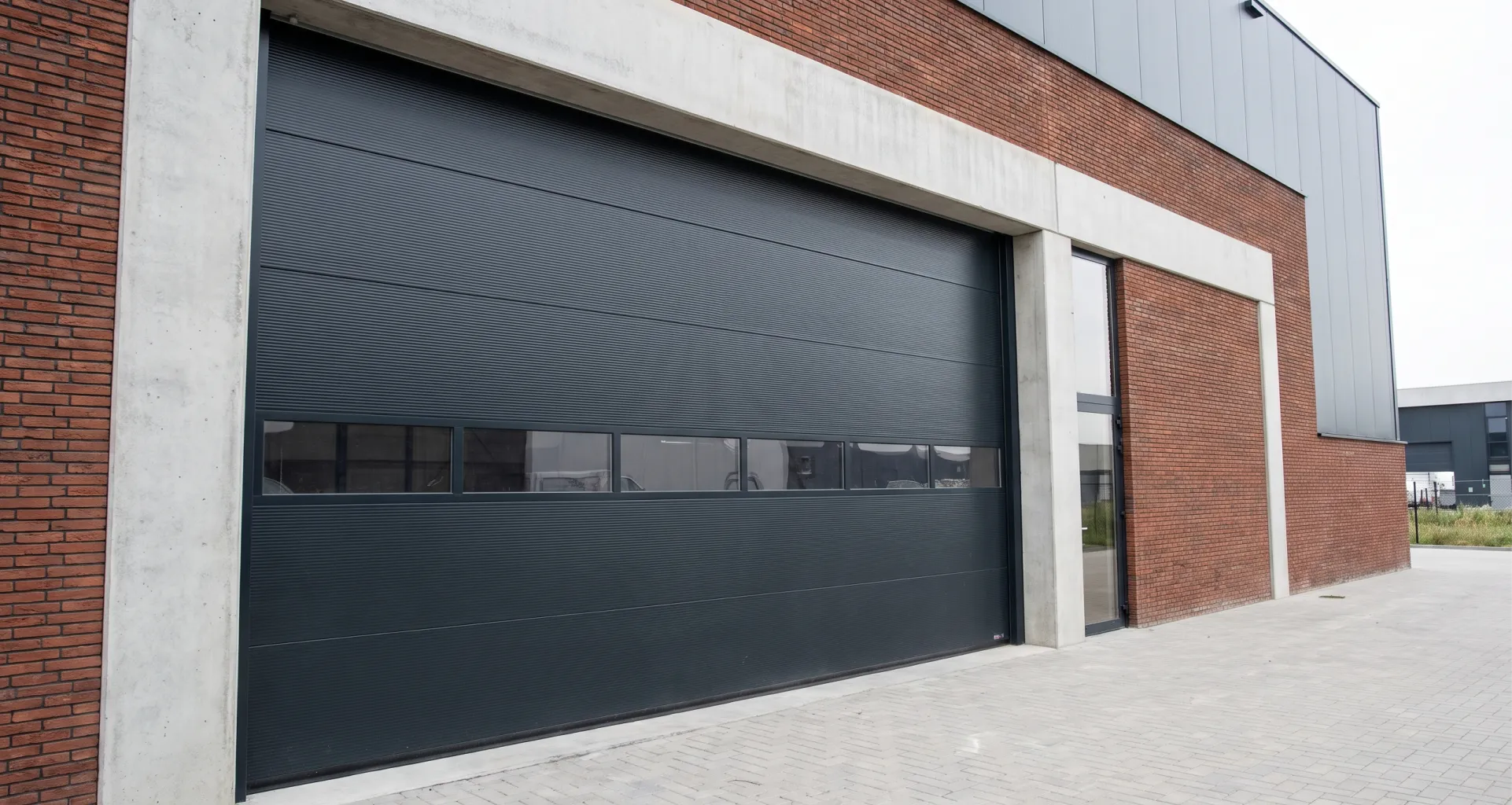 A large, dark grey rolling commercial garage door