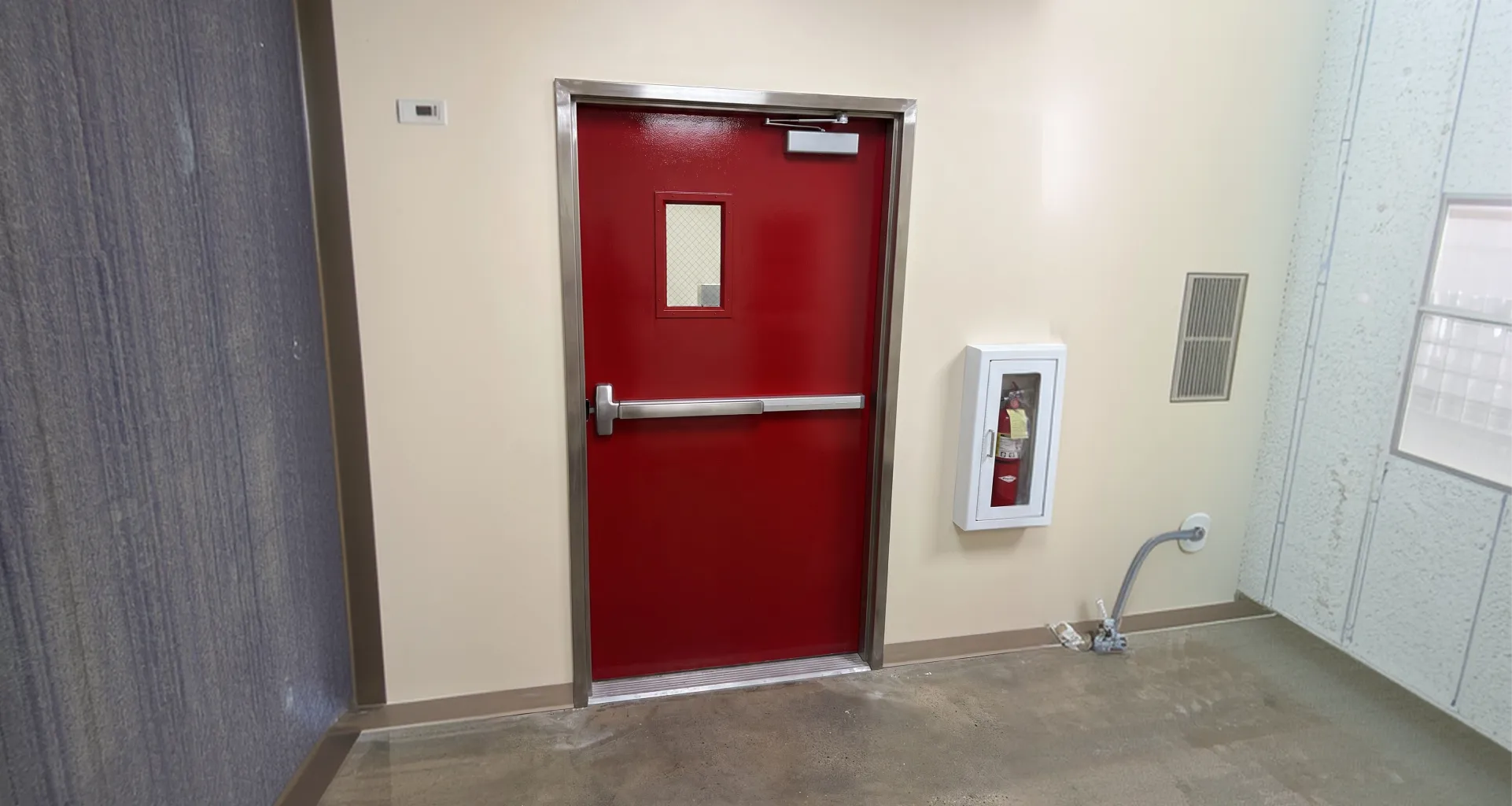 Overhead door closer being replaced on a fire-rated door